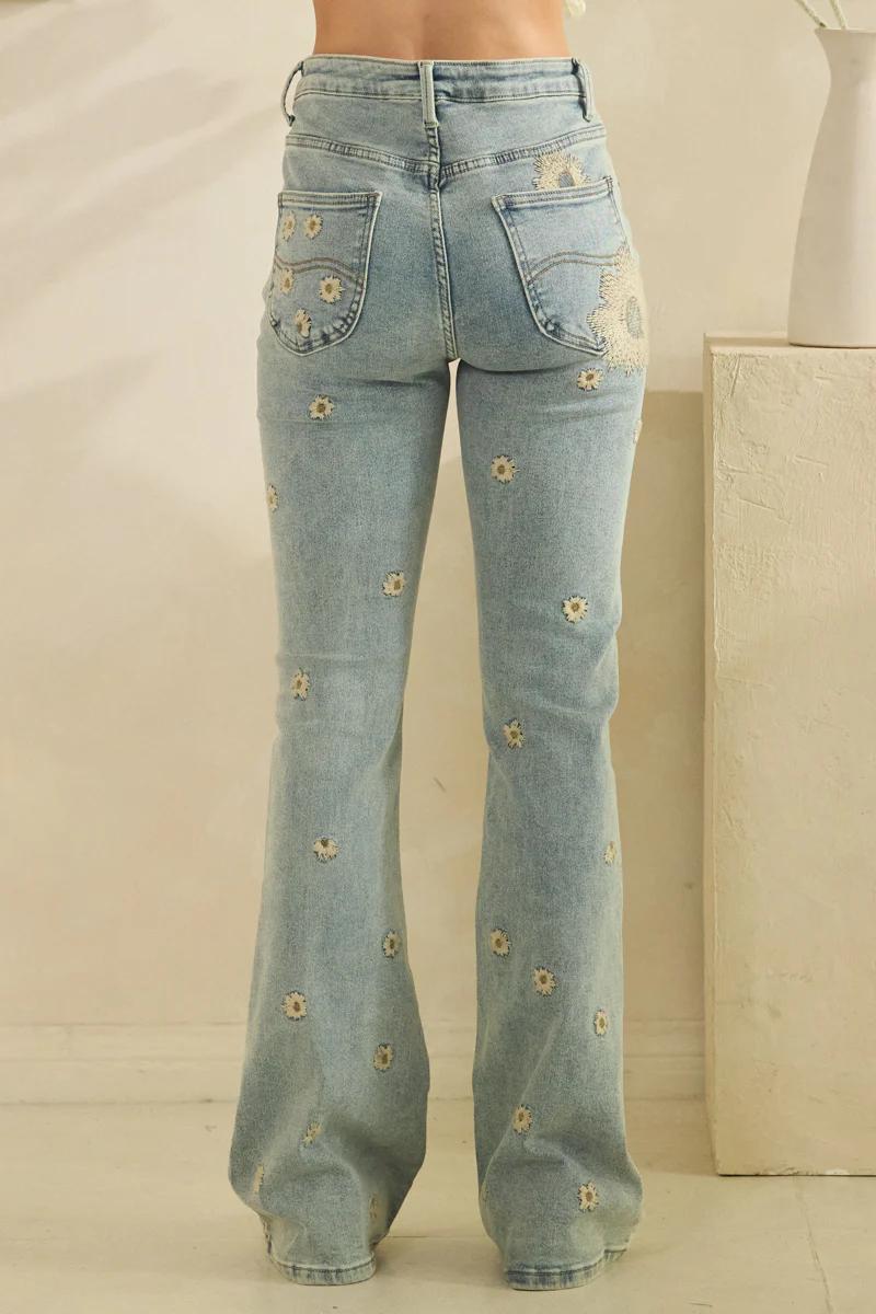 Artisanal finish and medium-weight denim texture of retro daisy bell bottoms