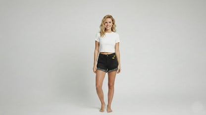 Side profile of Animecore black denim shorts showcasing the vintage wash and frayed edges.