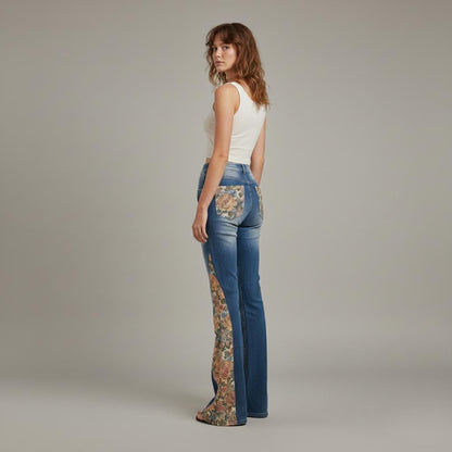 Close-up of intricate floral tapestry inlays on blue cotton denim cottagecore jeans.