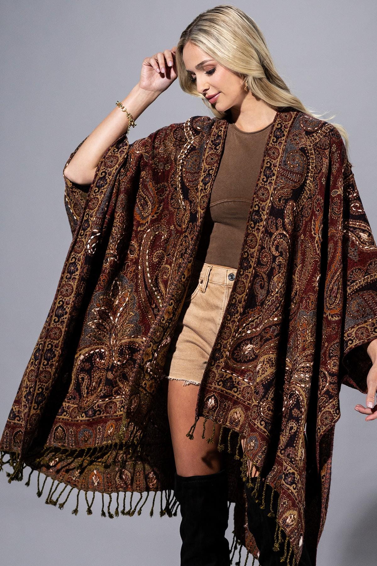 Back view of an oversized 100% wool wrap showing the intricate artisanal tapestry design