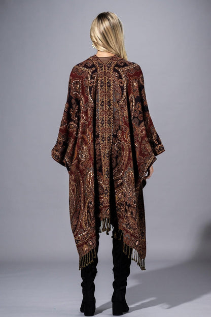 Flat lay of the deep burgundy artisanal-chic wool poncho highlighting the bronze paisley motif