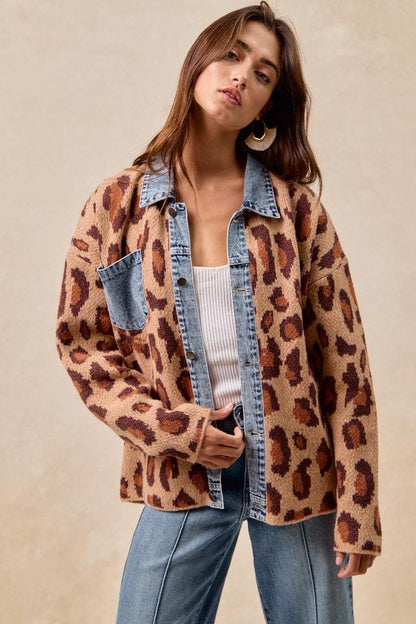 Detailed shot of the blue denim trim on the collar and pocket of the brown animal print shacket.