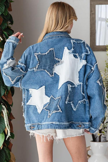Back of an oversized celestial patchwork jacket showing white star patterns on premium cotton distressed denim.