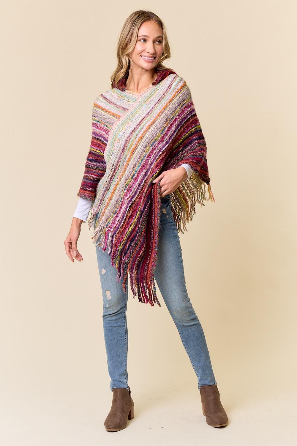 Back view of the woven acrylic poncho showing the vibrant striped pattern and hood