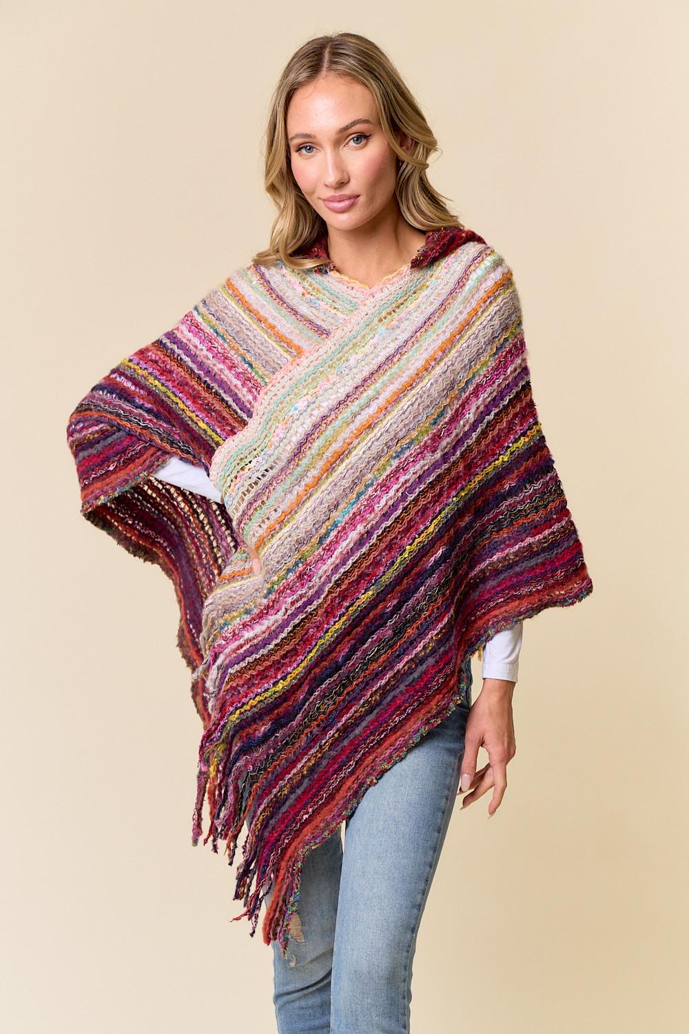Close-up of the textured acrylic weave and berry red fibers in the festival knit poncho