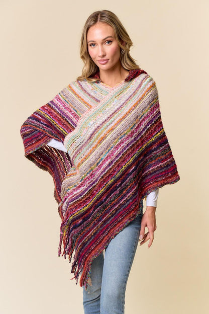 Close-up of the textured acrylic weave and berry red fibers in the festival knit poncho