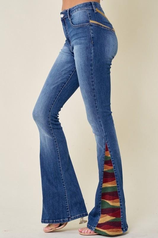 High-waisted fit detail of boho denim jeans featuring classic five-pocket styling and button closure