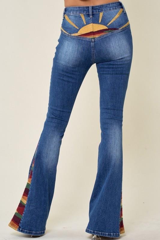Low angle view of wide flare bell bottoms highlighting the vibrant striped fabric and 70s style