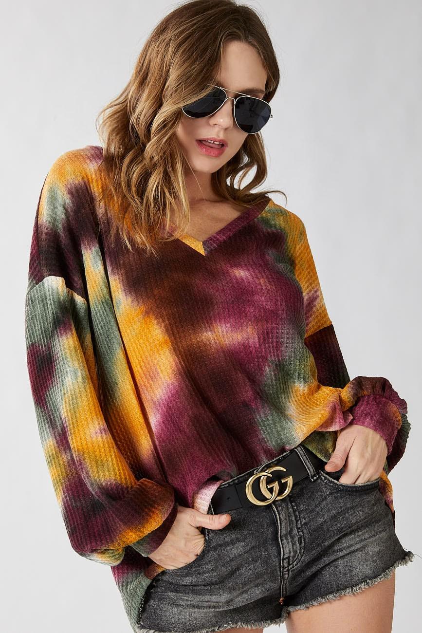 Front view of the Tie Dye Oversized Poly Blend Ribbed V-Neck Top in mustard yellow and maroon tones.