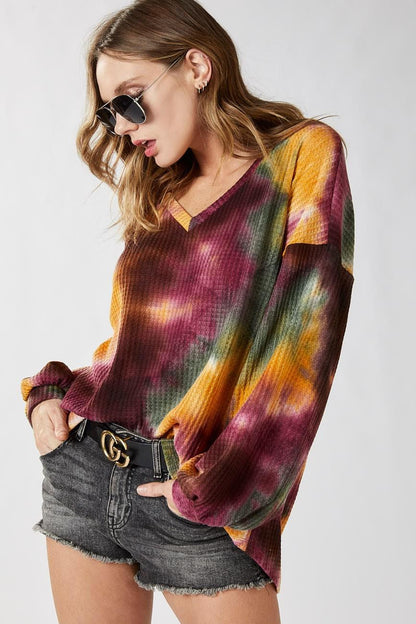 Back profile of this boho-chic oversized v-neck top showing the relaxed 70s-inspired silhouette.