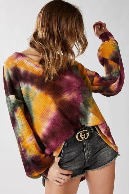Side angle of the drop-shoulder tie dye top highlighting the soft poly blend material and oversized fit.