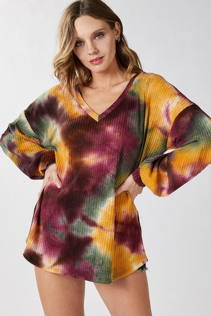 Zoomed view of the ribbed sleeve cuff on the multicolored hippie modern tie dye sweater.