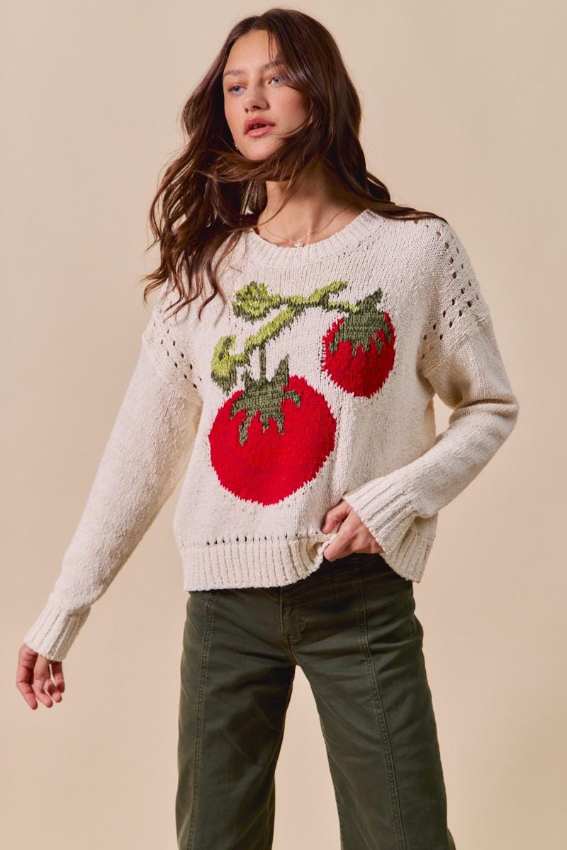Back of the whimsical cottagecore pullover featuring a relaxed fit and ribbed hem