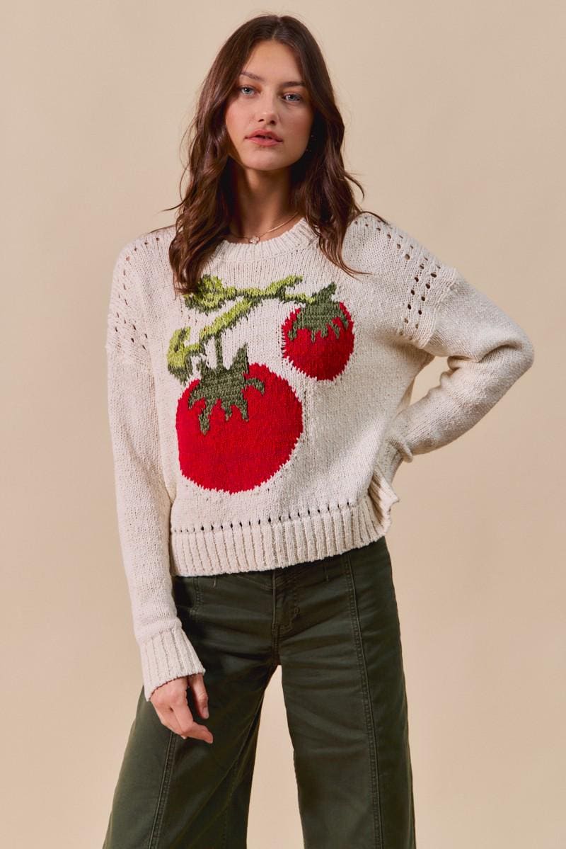 Close-up detail of the vibrant red tomato graphic and delicate pointelle open-knit texture