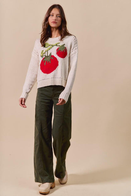 Close-up of the soft cotton blend material and intricate knit pattern on this red and cream jumper