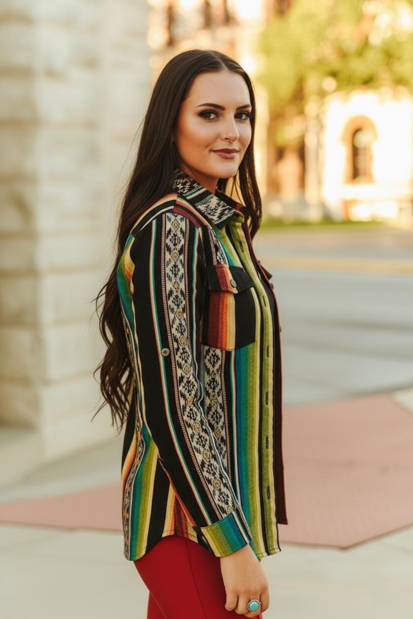 Side profile of the red earth-toned tribal jacquard blouse highlighting the adjustable roll-tab sleeve detail