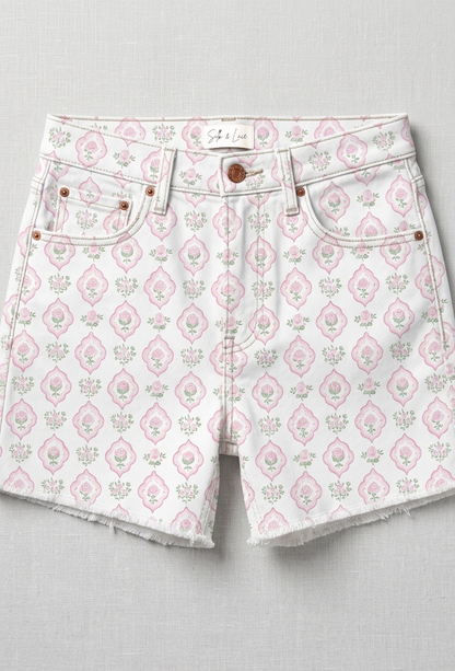 Model wearing vintage floral denim shorts for a summer garden party aesthetic with a casual raw-edge finish