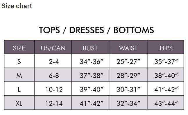 Detail shot of the high-quality garment construction and delicate lace inserts on the shoulder.