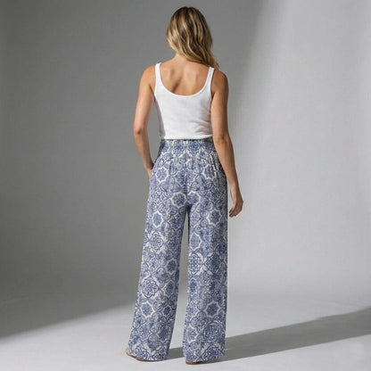 Rear view of flowy tall linen trousers featuring an Amalfi Coast inspired blue tile pattern
