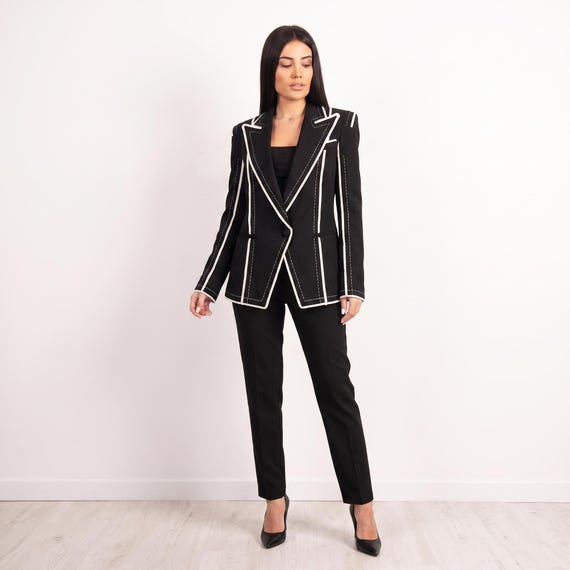 Women's black blazer with white contrast stitching, tailored silhouette