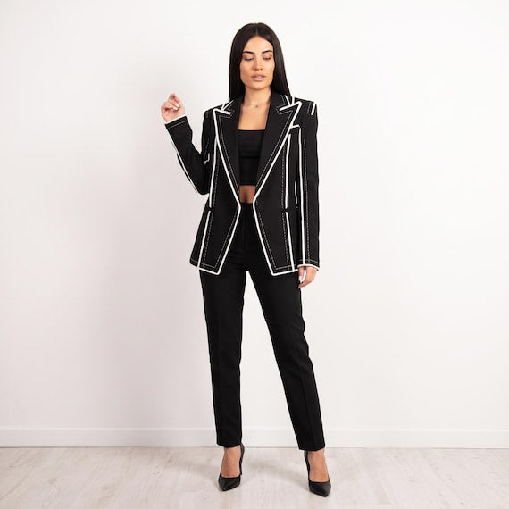 Back view of avant-garde black blazer with sharp princess seams