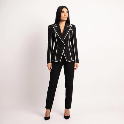 Lifestyle shot: Woman wearing statement black blazer for power dressing
