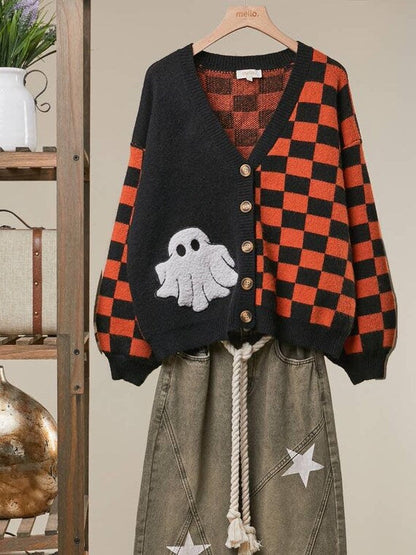 Close-up of the soft white chenille ghost patch on the black knit panel of the spooky autumn cardigan