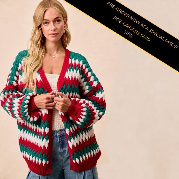 Front view of an oversized Christmas cardigan with a red, green, and white festive diamond knit pattern