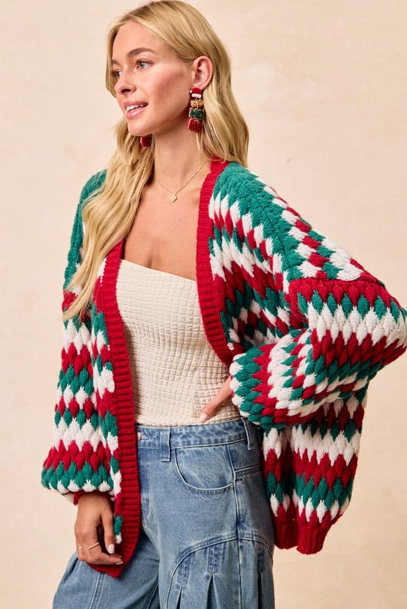 Side view of the relaxed silhouette holiday cardigan, highlighting the drape and soft polyester knit
