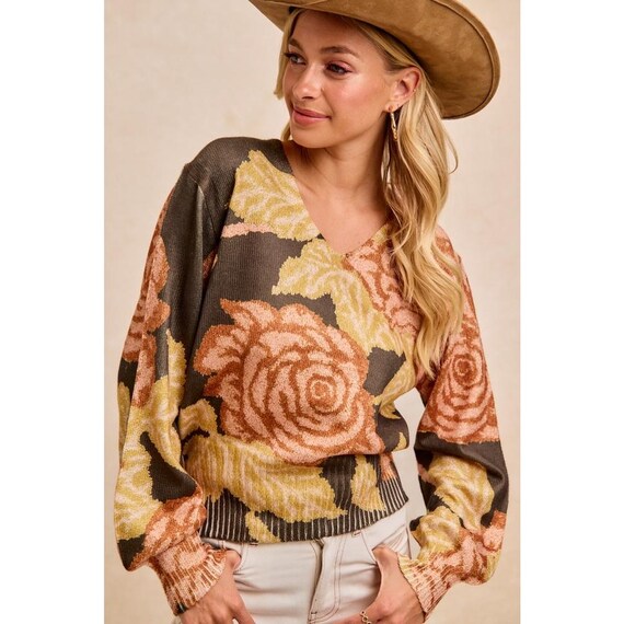 Whimsigoth dark floral knit V-neck sweater with balloon sleeves in olive green and peach, styled with a tan cowboy hat.