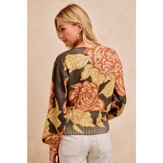 Back view of the slouchy knitwear showing its relaxed silhouette and elongated drape
