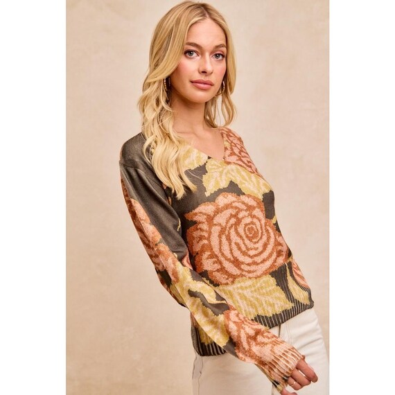 Close-up of the premium cotton blend jacquard weave on this earthy floral print sweater