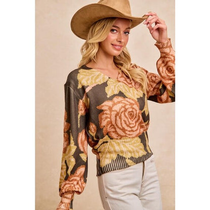 Detailed shot of the V-neck collar and rustic peach and gold accents on the olive botanical top