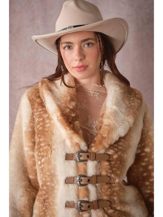 Close-up of plush faux fur texture on women's deer print jacket