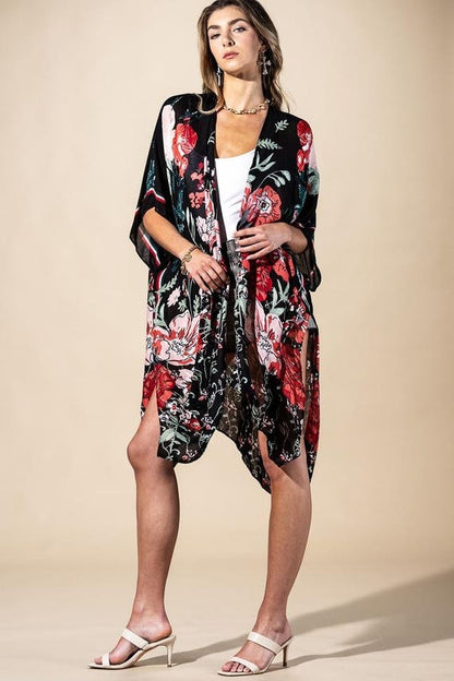 Styled shot of a woman wearing a whimsigoth black floral kimono cardigan for a bohemian look.