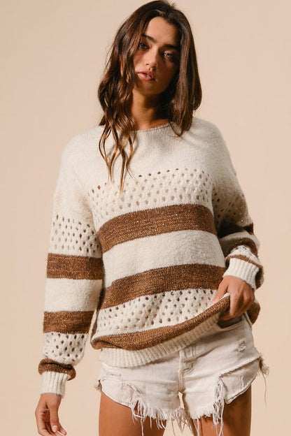 Women's boho casual cream and brown striped knit sweater featuring perforated details and a relaxed crewneck fit.