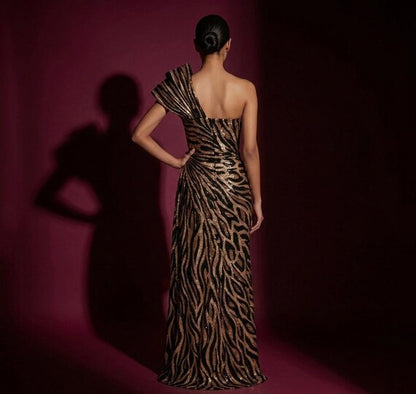 Back view of a women's one-shoulder sequined mermaid gown in a shimmering bronze and black zebra print.