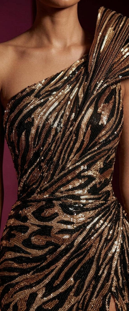 Close-up of a bronze sequined one-shoulder mermaid gown featuring a bold zebra and leopard print pattern.