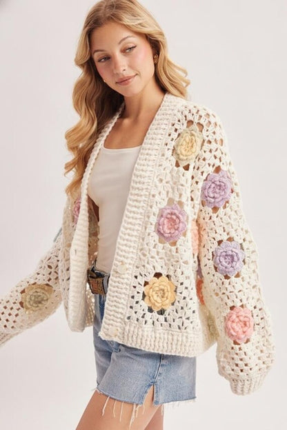 Coquette aesthetic: ivory open stitch cardigan draped over an outfit, showcasing its airy texture