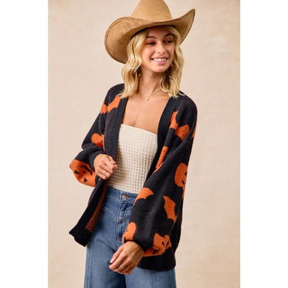 Women's cozy Whimsigoth open-front cardigan, dark grey with orange pumpkin & bat print, long balloon sleeves, relaxed knit fit.