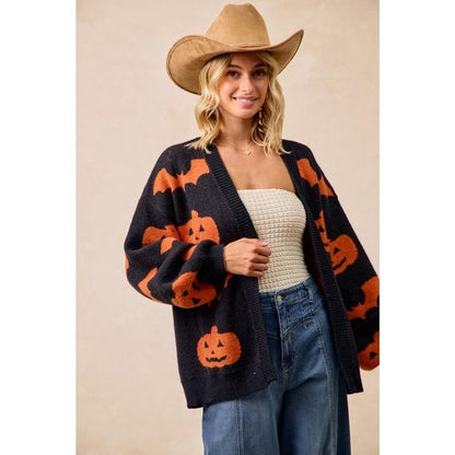 Cozy Whimsigoth black knit open-front cardigan with orange pumpkin and bat print, featuring a relaxed fit and extended sleeves.