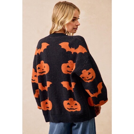 Close-up of the playful pumpkin and bat artwork on this mid-weight Whimsigoth knit sweater texture.