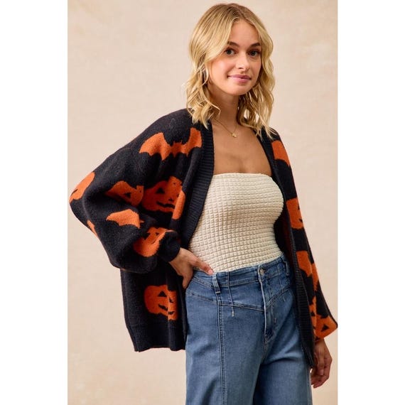 Model wearing an oversized Pumpkin Bat Print Cardigan, a cozy autumn jacket with long sleeves for chilly days.