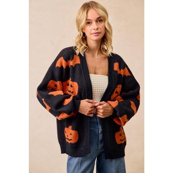 Side view of the orange and black Open Front Cardigan, featuring a slouchy knit and drop shoulder design.