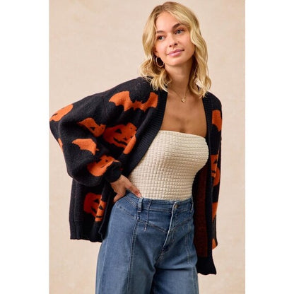 Full length view of the Whimsigoth Bat Knit Sweater, showcasing its relaxed drape and extended silhouette.