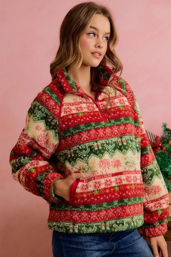 Smiling woman wearing warm sherpa quarter zip fleece for a cozy holiday party look.