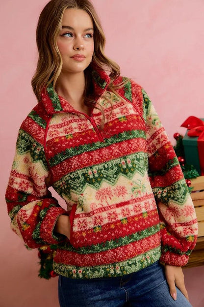 Flat lay arrangement of cozy winter fleece pullover with festive holiday mugs and winter boots.