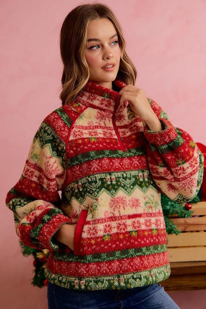 Folded view of ultra-plush Christmas sweater pullover highlighting vibrant red, green, and cream details.
