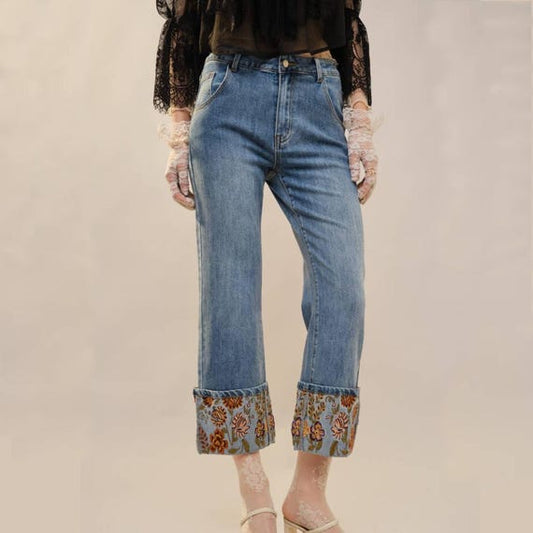 Front view of women's straight leg jeans with embroidered floral cuffs