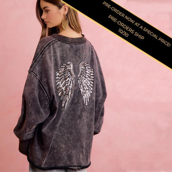 Back of women's edgy grunge revival sweatshirt with large sequin angel wings